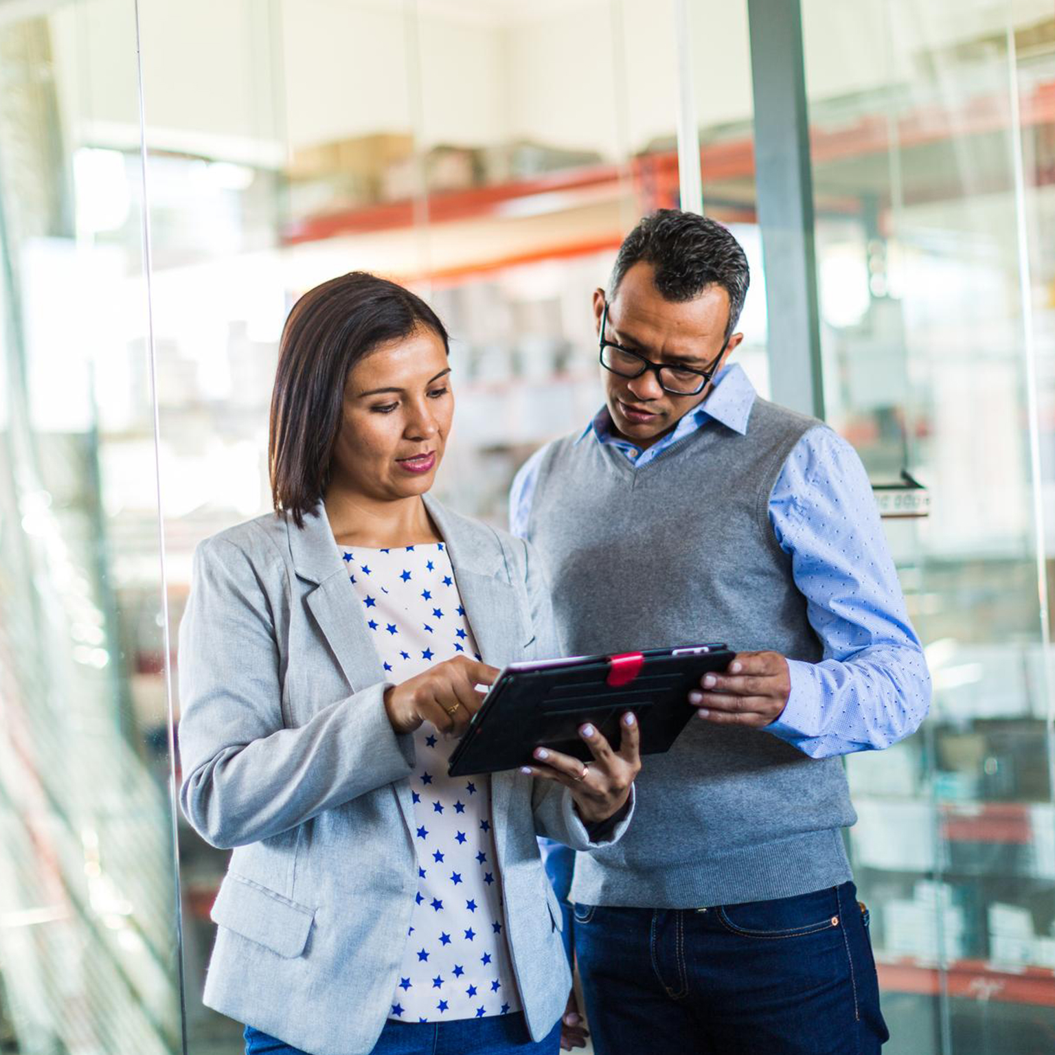 Colleague sharing ipad with colleague