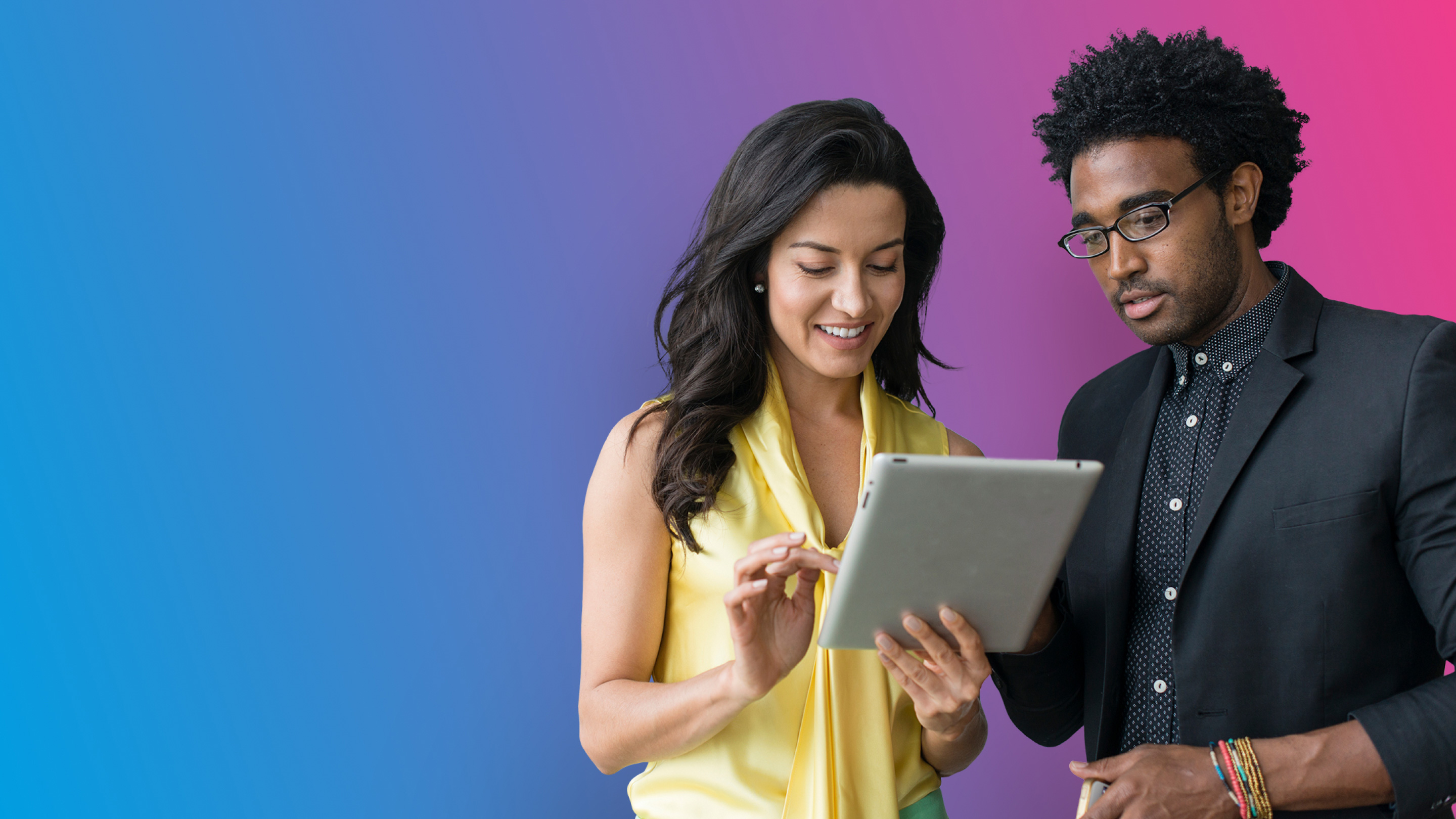woman sharing office tablet with man