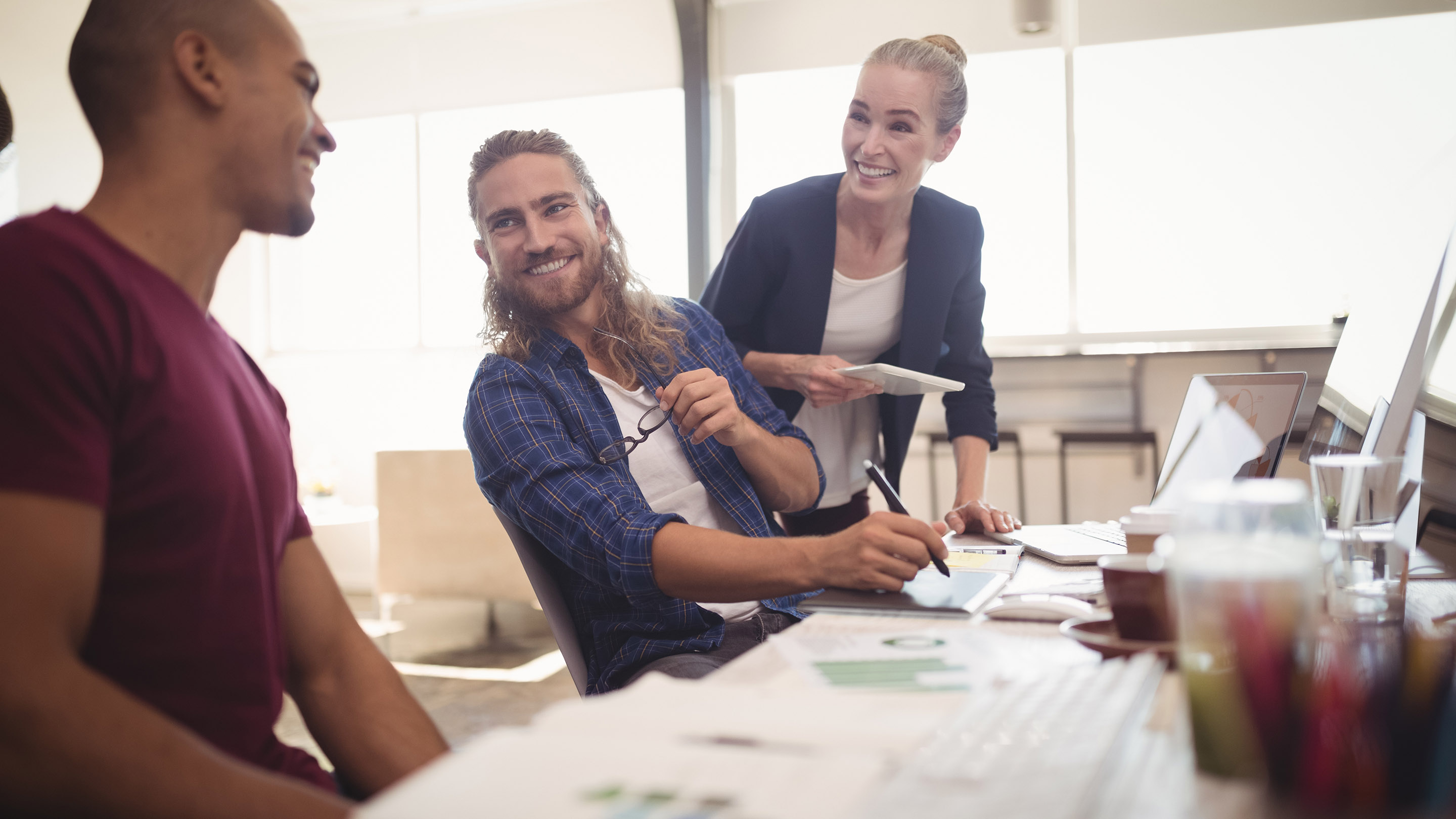 Happy business colleagues working together at creative office