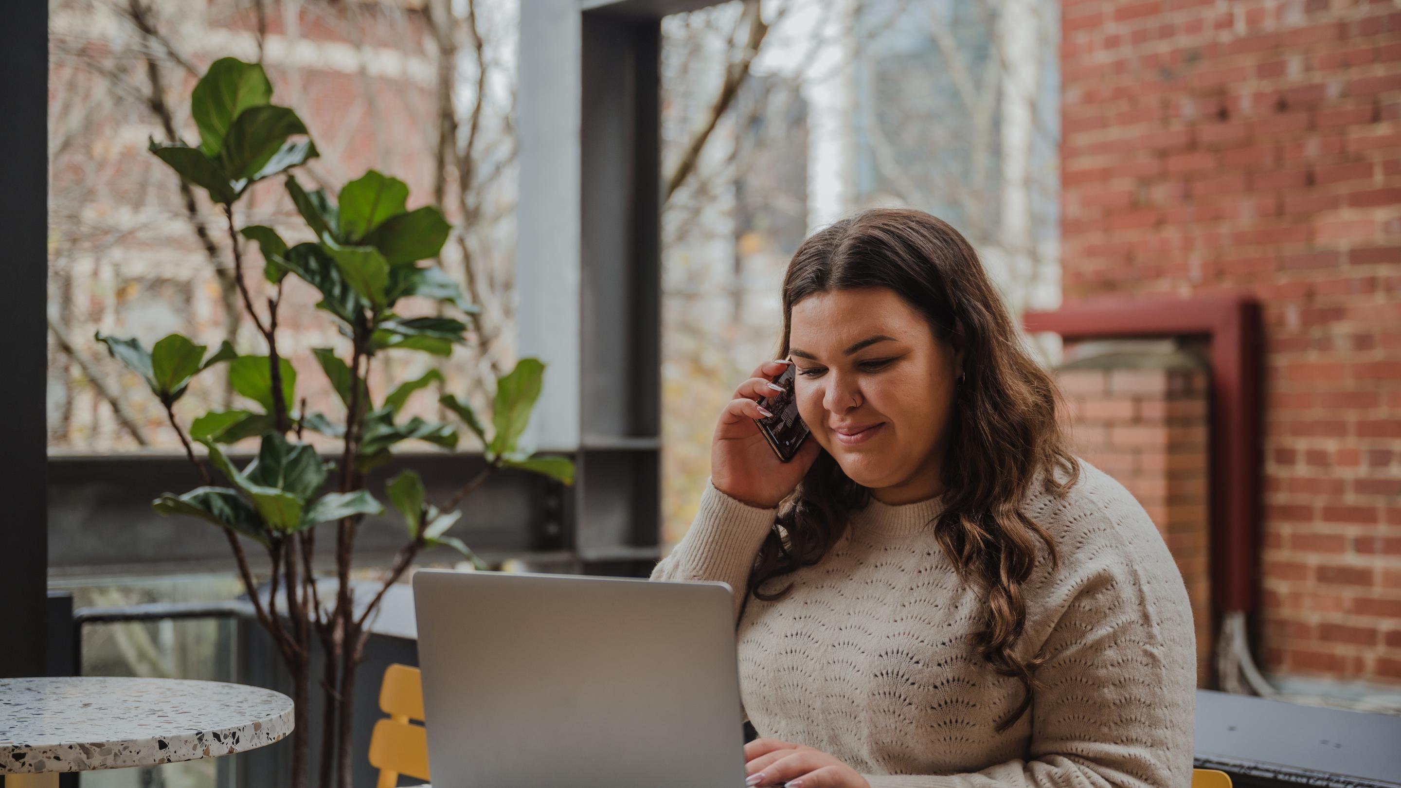 Young woman multi-tasking at work