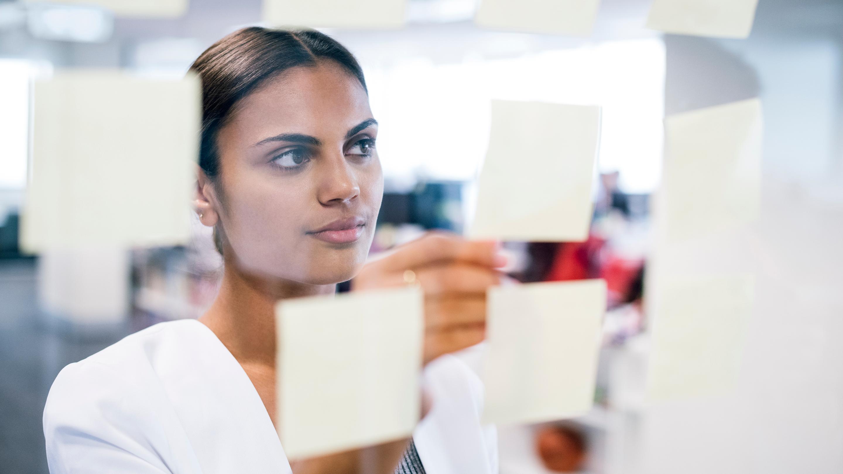 Female office worker brainstorming.