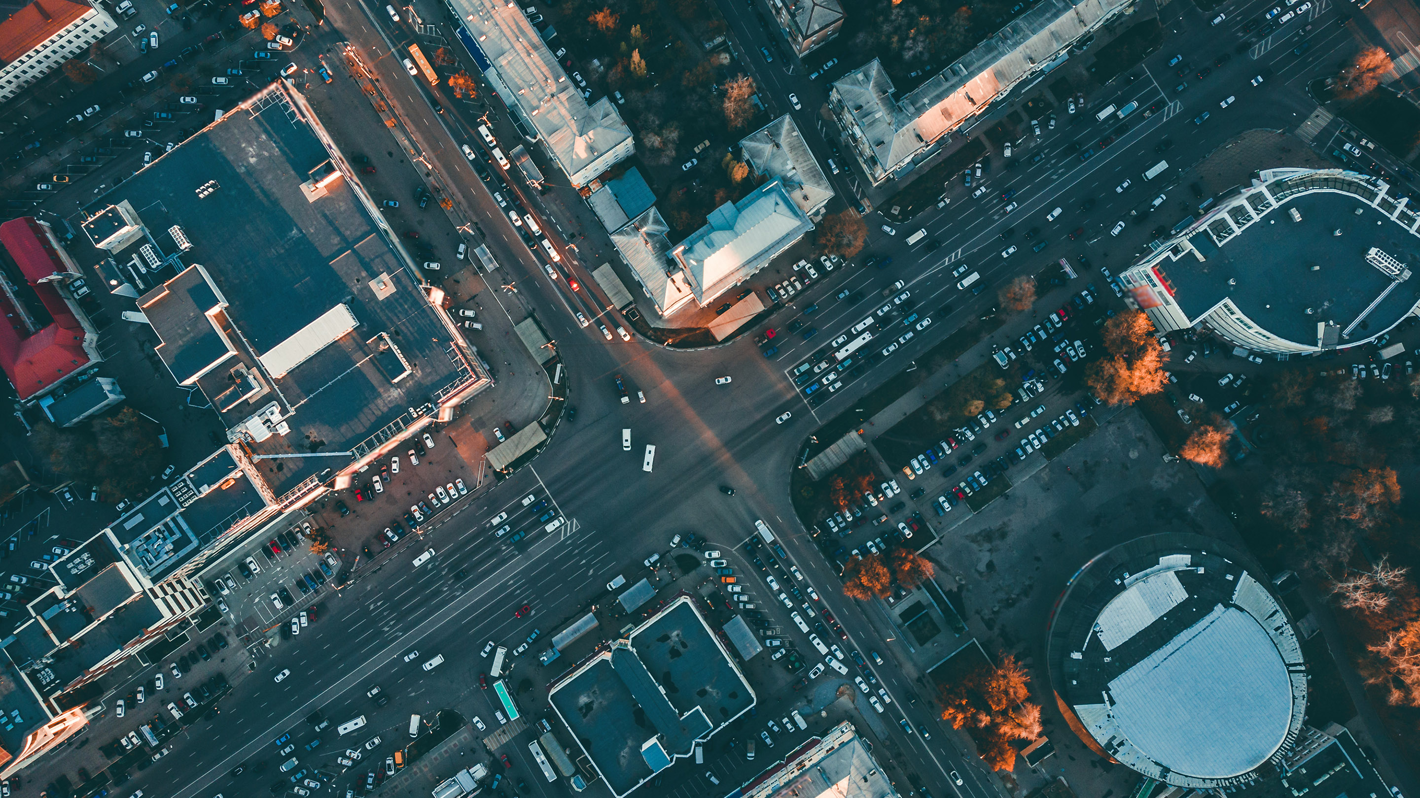 Aerial top view of city asphalt roads with lot of vehicles or car traffic and buildings, modern urban intersections and junctions in midtown, toned
