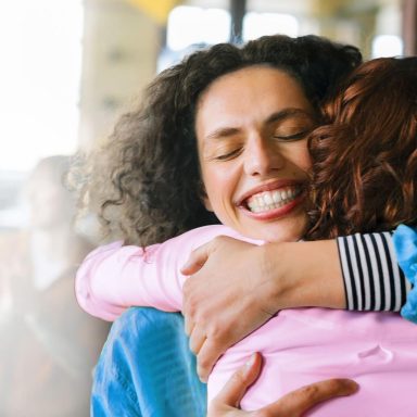 Closeup of office workers hugging