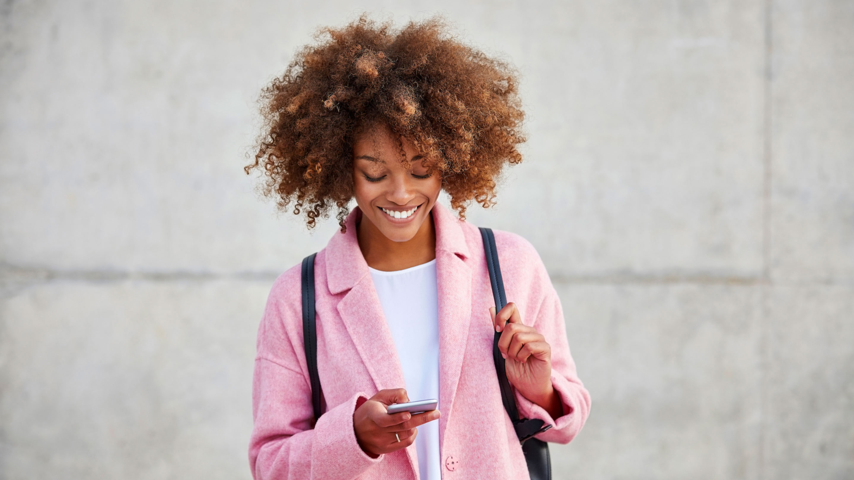 Happy young woman messaging smart phone