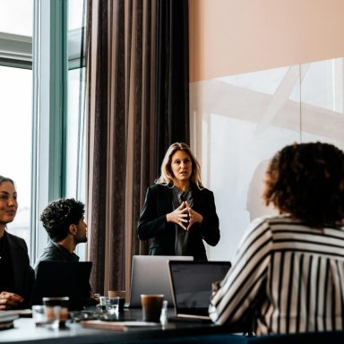 Group meets for discussion in office with large windows