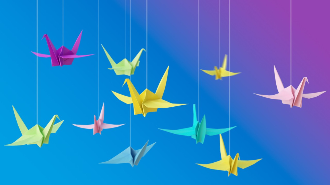 Origami colorful birds hanging on string