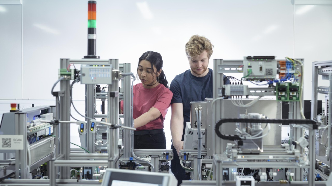 Young man and women working in a technical surrounding