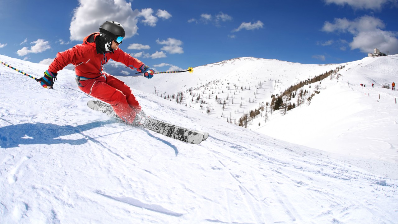 Aktiver Mann beim Skifahren bergab 