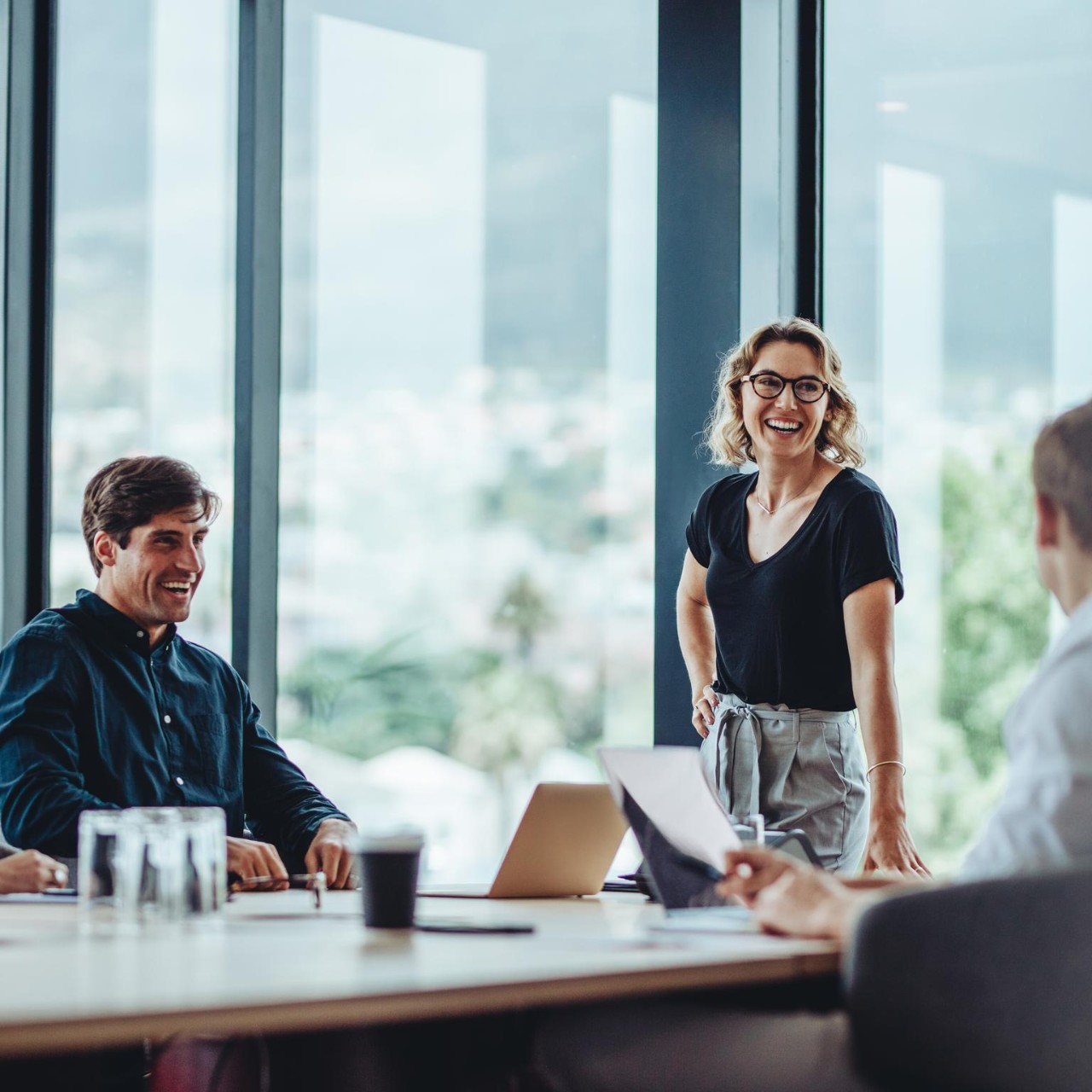 Office colleagues having casual discussion during meeting in conference room