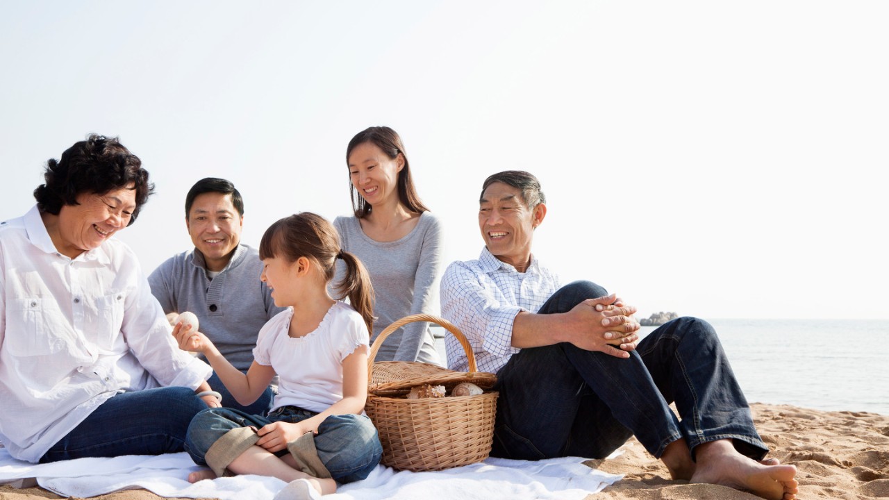 Chinese family having picnic on beach