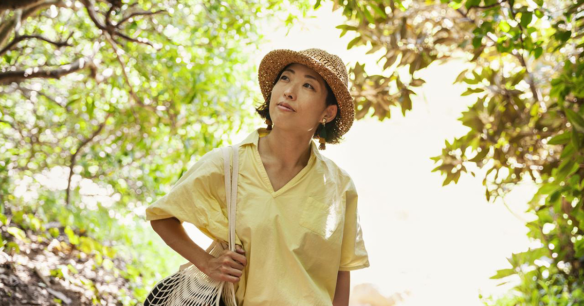 Woman walking through a wooded area