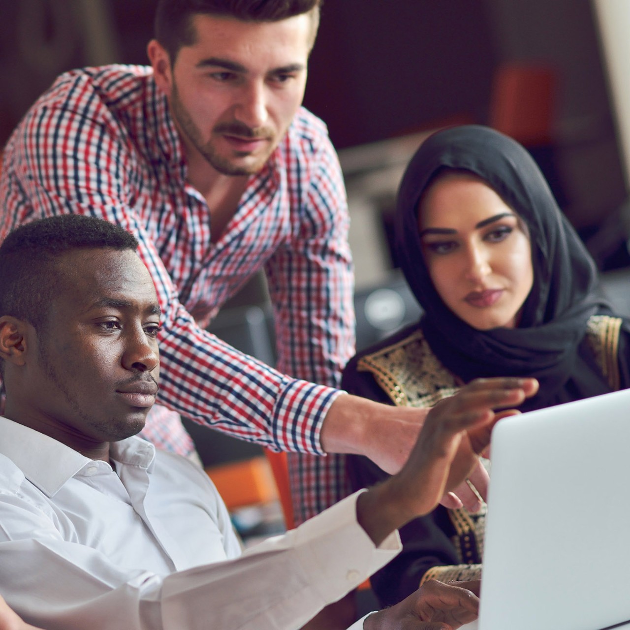  Multiracial contemporary business people working connected with technological devices like tablet and laptop, talking together - finance, business, technology concept