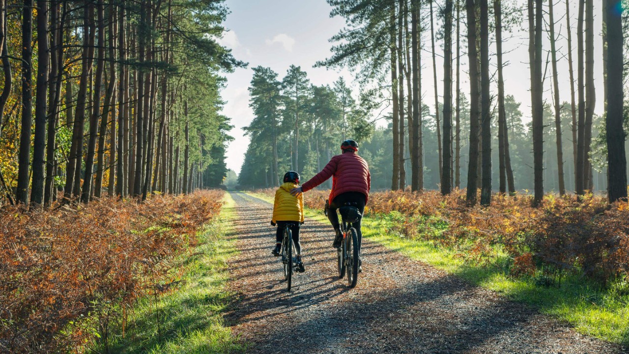 The mature father helps his daughter by giving her a helping hand
