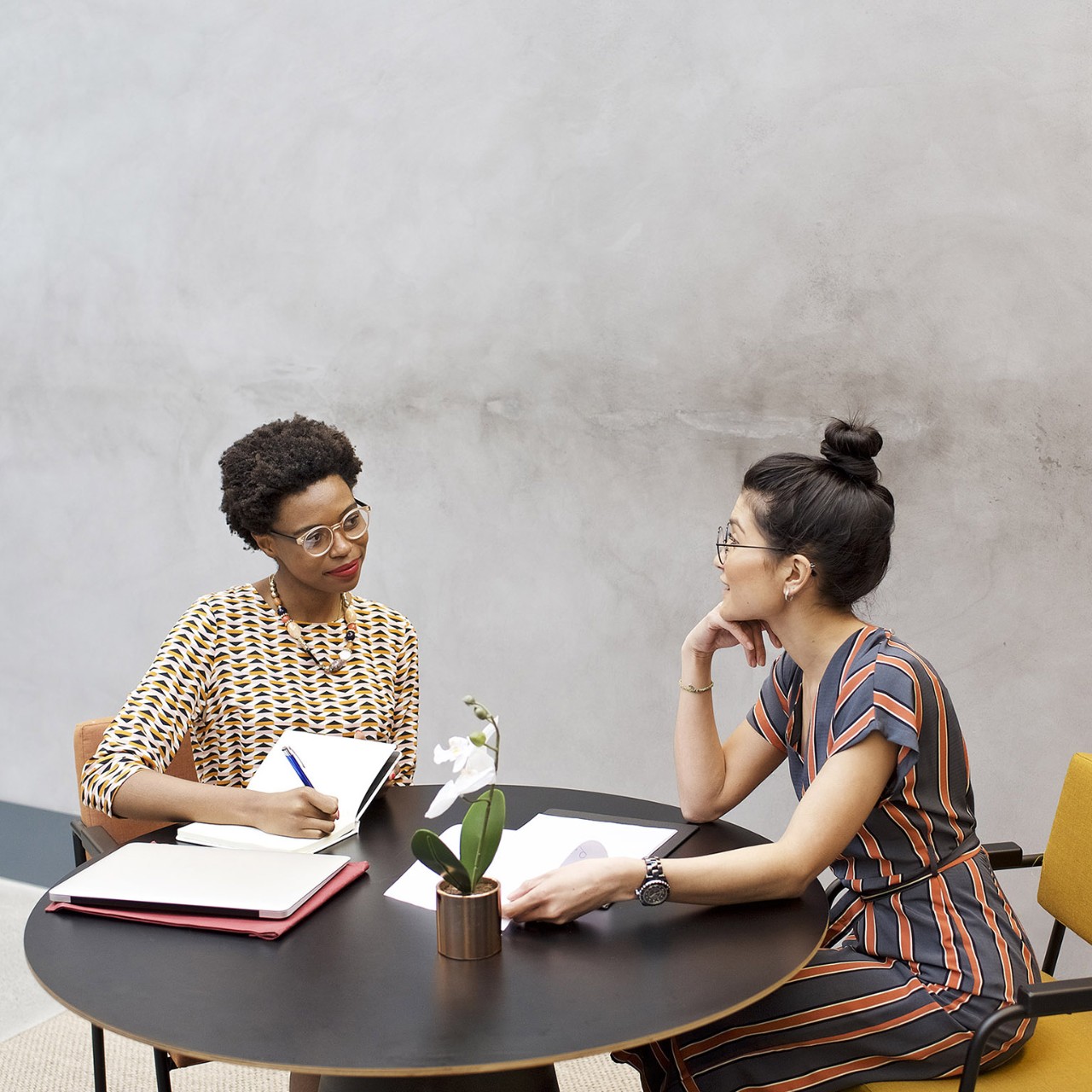 Black African and Asian businesswomen in a meeting