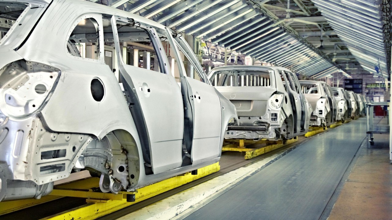 Assembled cars in a row at car plant