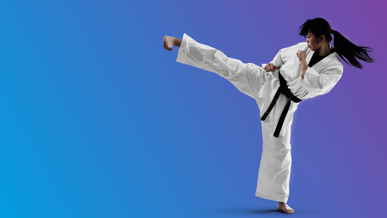 karate player kicking on blue and purple background 