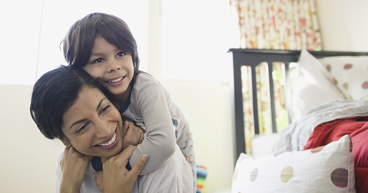 Mother and son hugging in bedroom 1200x630