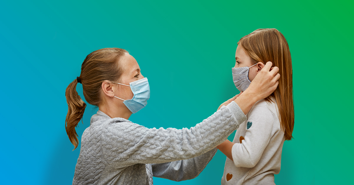 A woman and little girl wearing masks