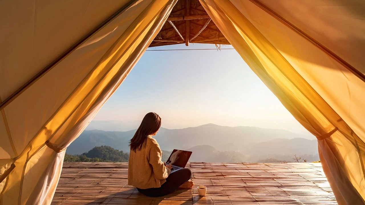 Young woman freelancer traveller working online using laptop