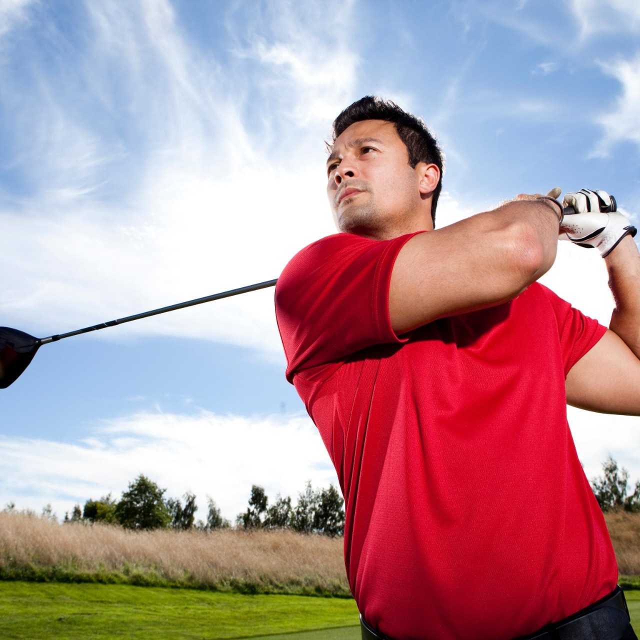 Man hitting ball golf course