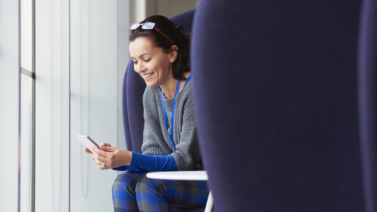 Woman smiling using smartphone