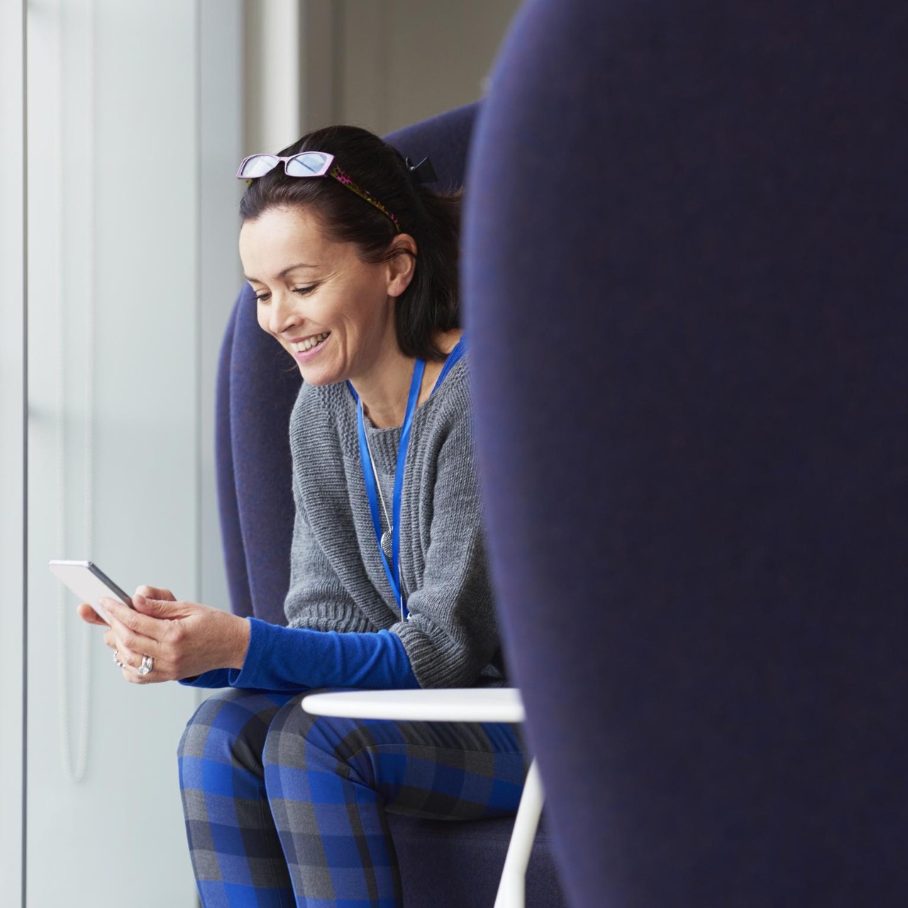 Woman smiling using smartphone