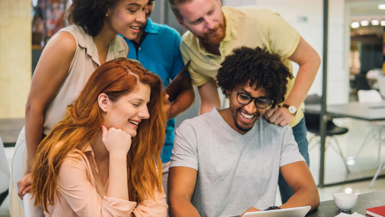 Group of young people looking at a tablet