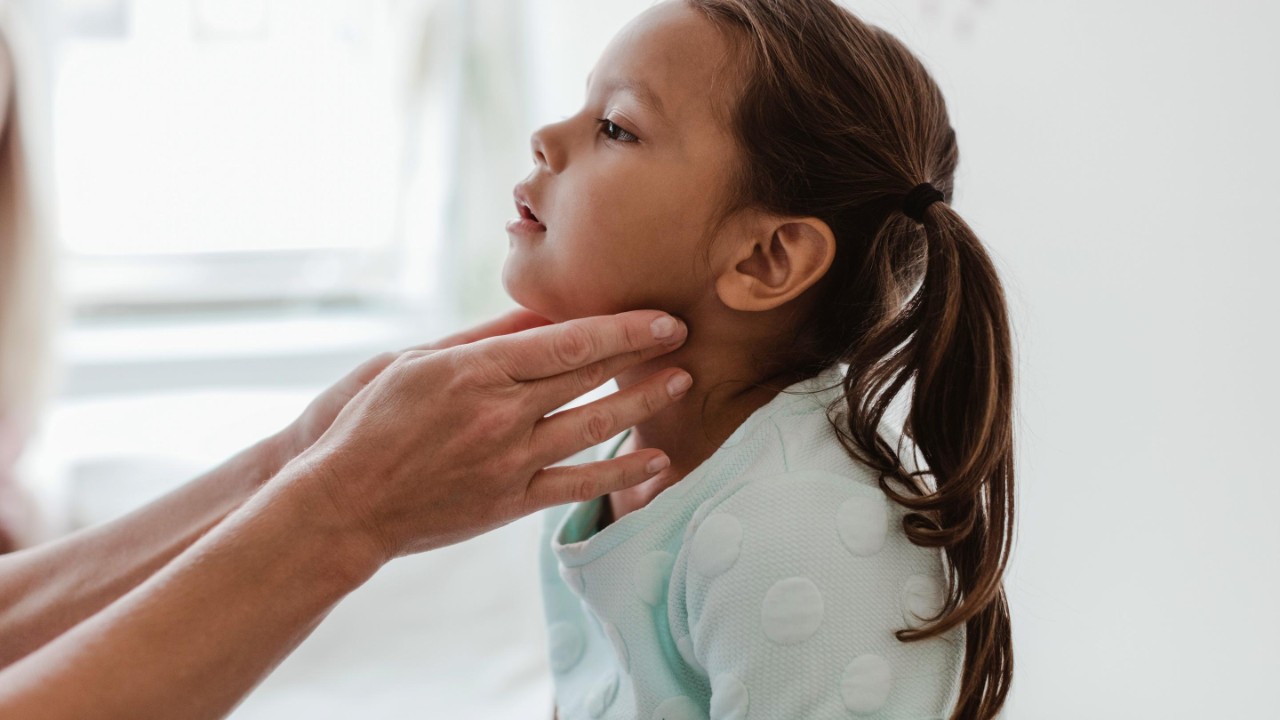 Girl has glands checked by medical professional