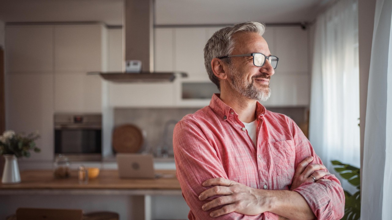 man looking out of the window and smiling