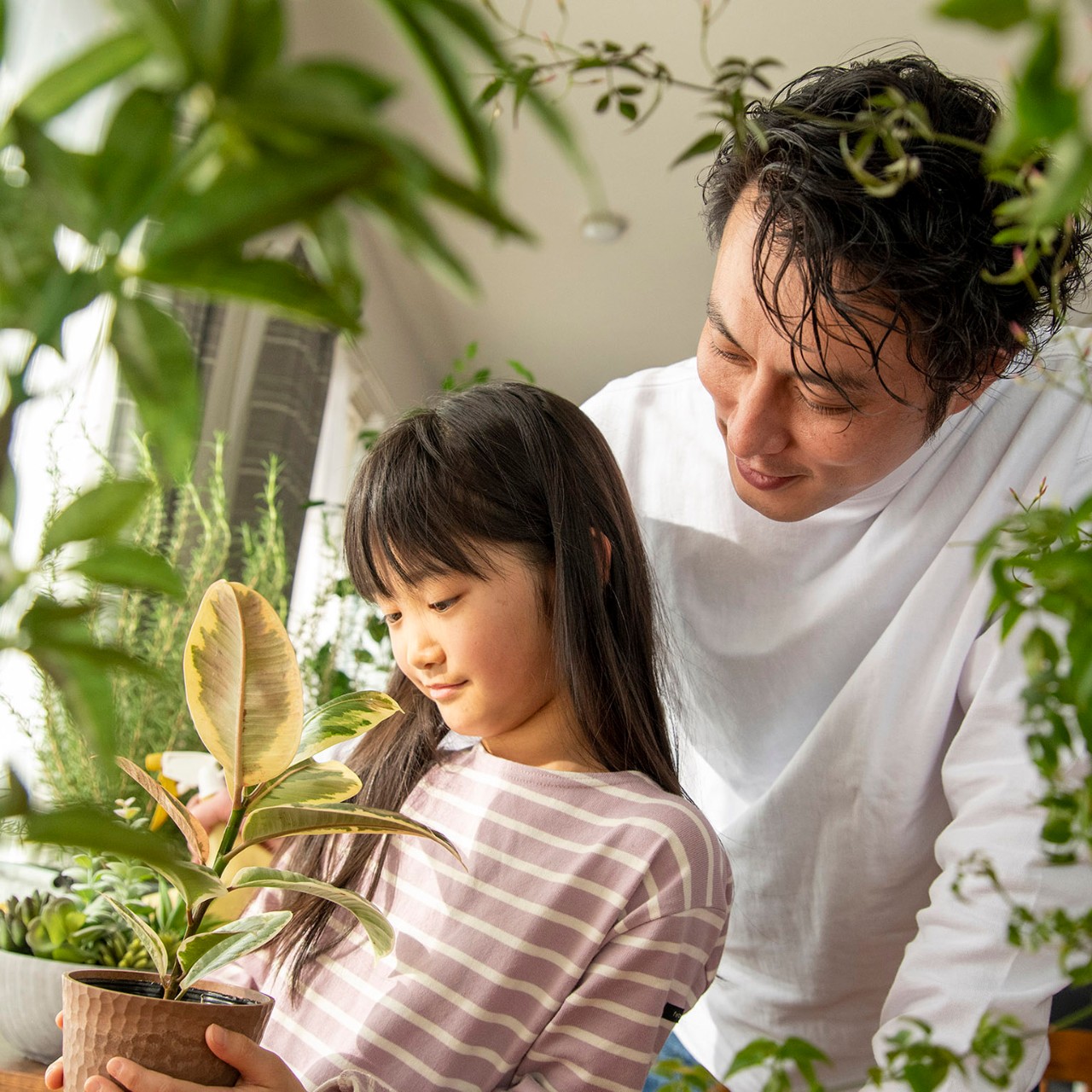 father and daughter with plants