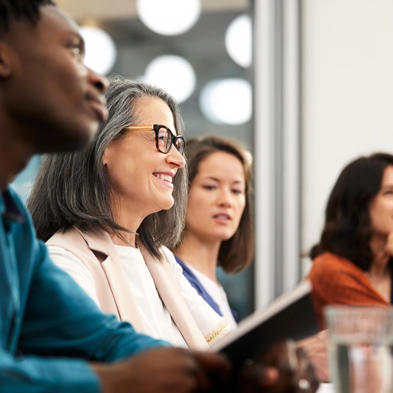 closeup-of-smiling-colleague-in-meeting