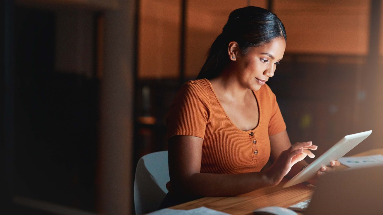 Young business woman on iPad smiling