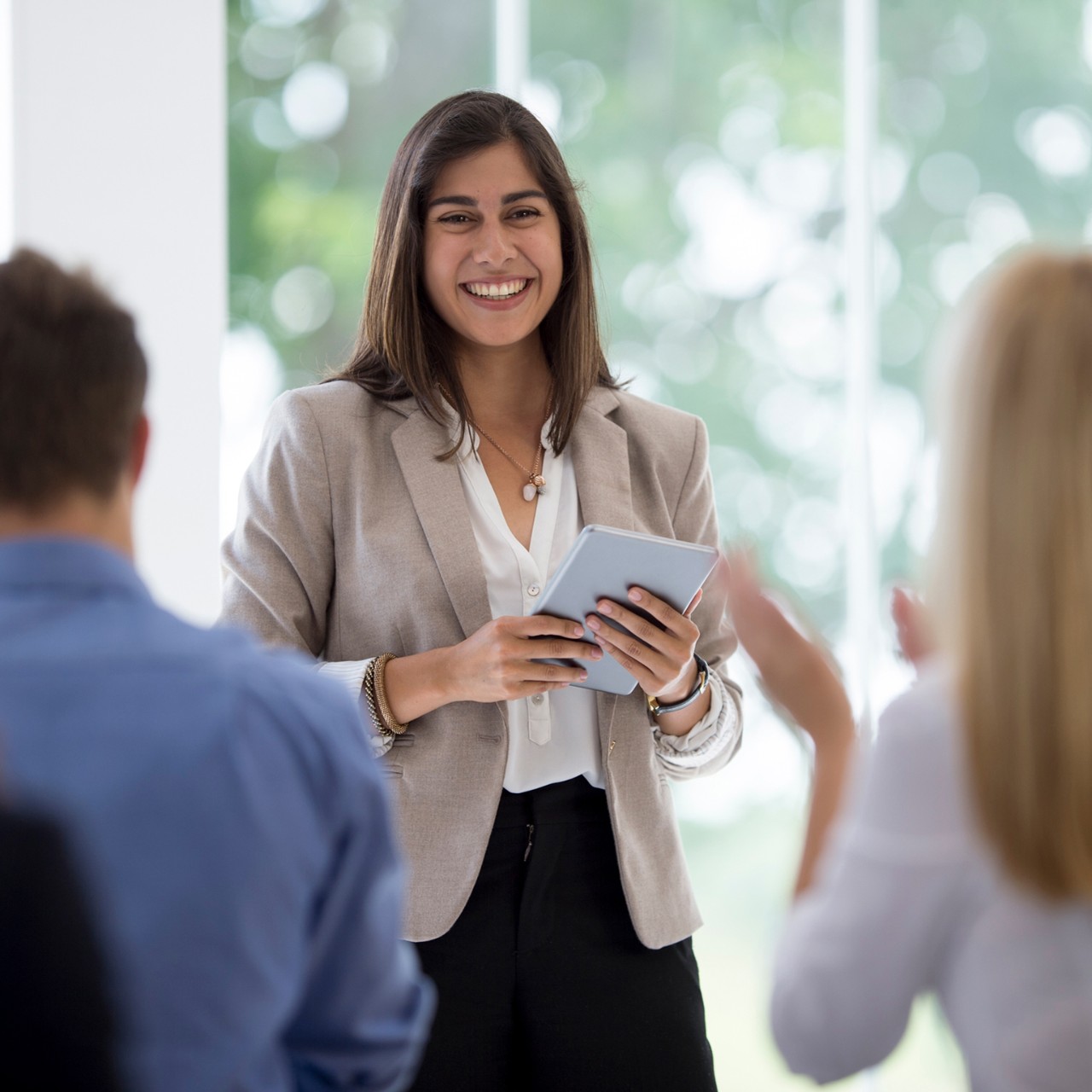 Multi-ethnic group clapping after a presentation.