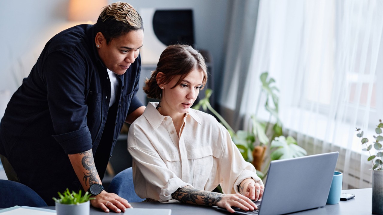 Two women working on a laptop