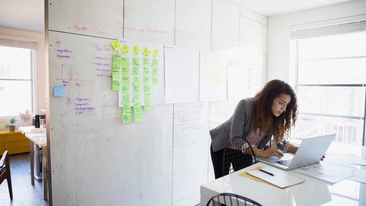 woman standing at a laptop