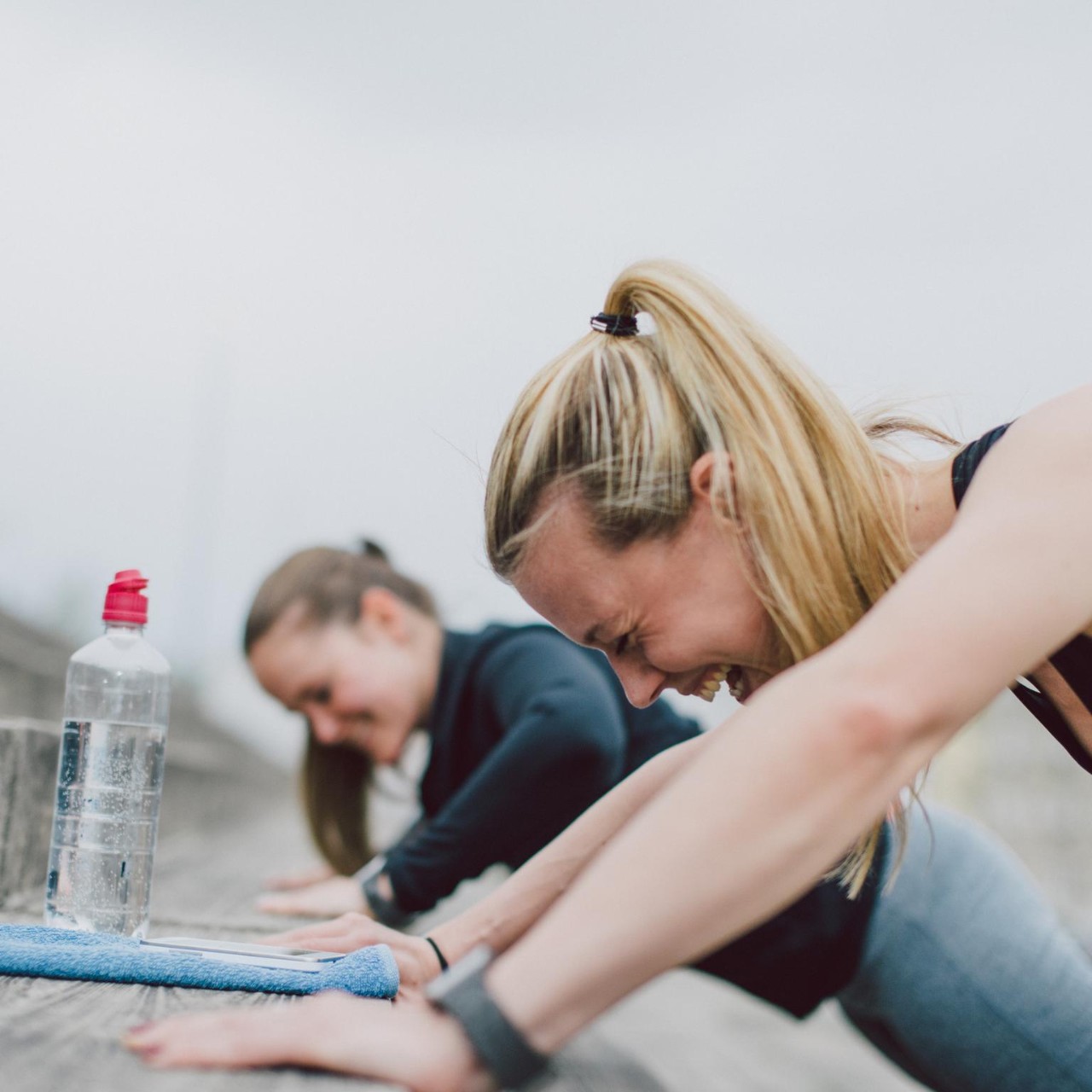Girlfriends doing push-ups together and having fun