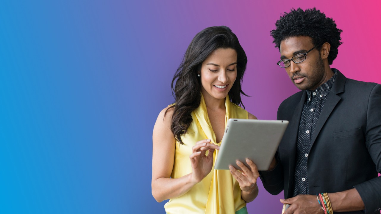 woman sharing office tablet with man