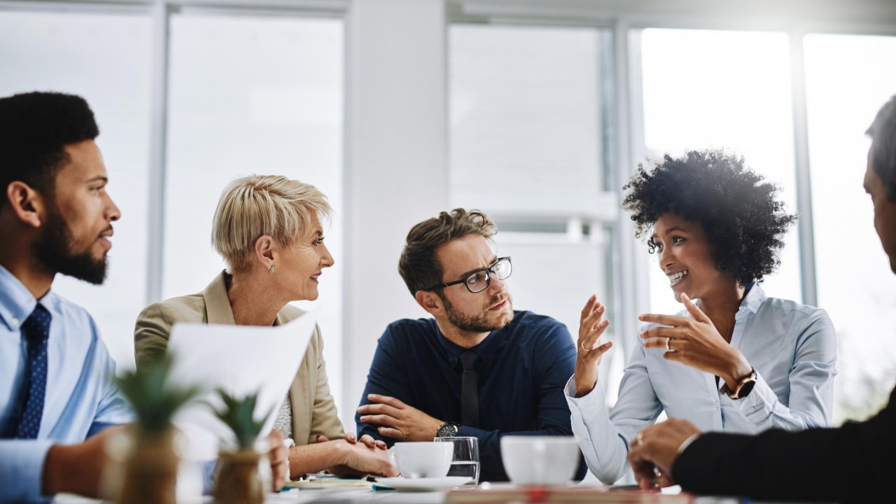 Shot of a group of businesspeople sitting together in a meeting