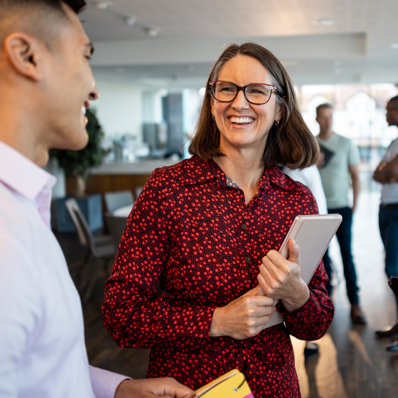 Medium shot of a mixed ethnic group of business professionals at a networking conference