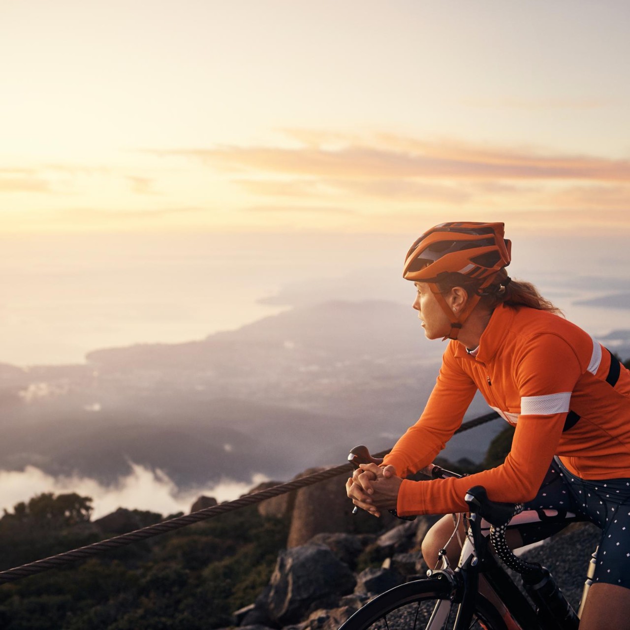 Young woman cycling in the mountains