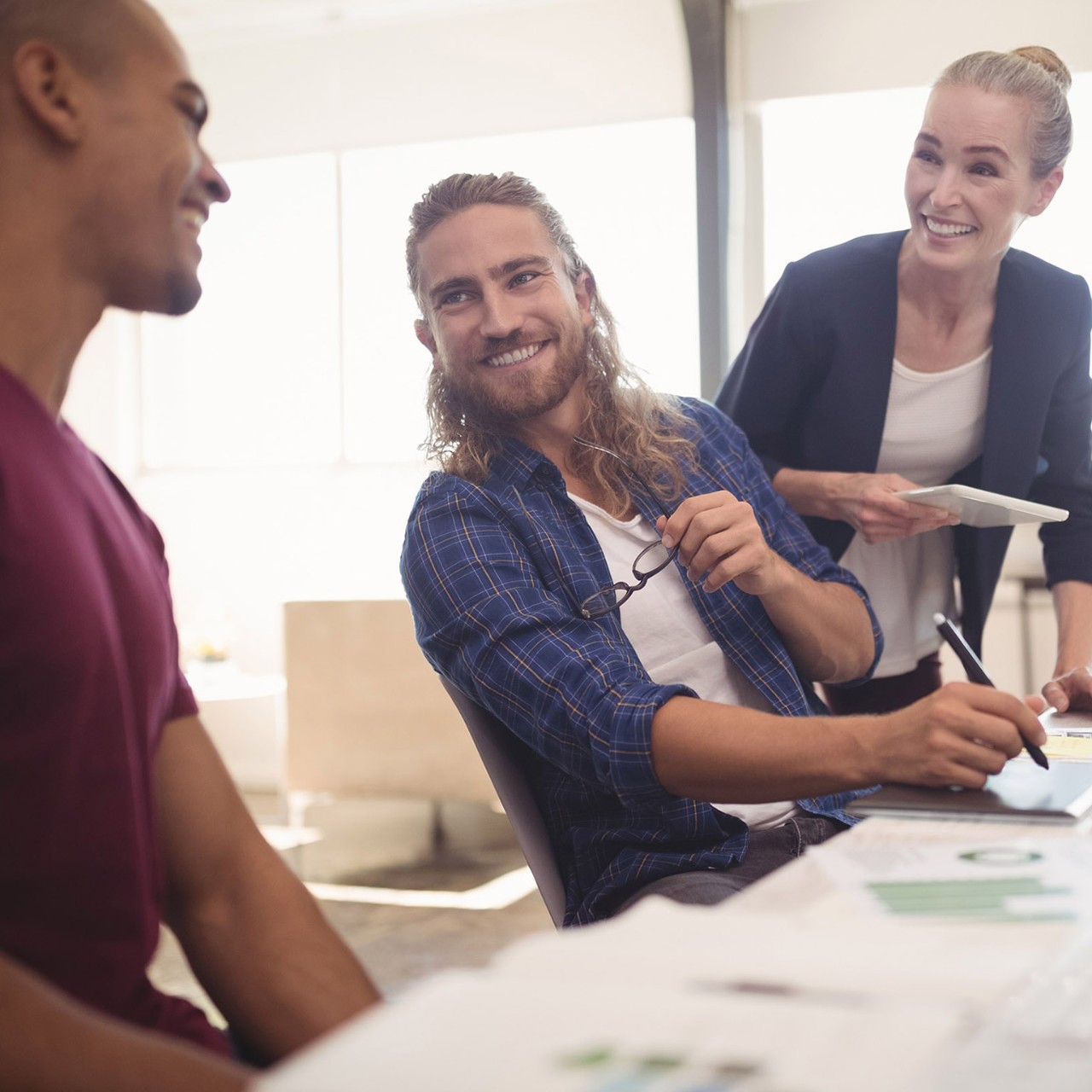 Happy business colleagues working together at creative office