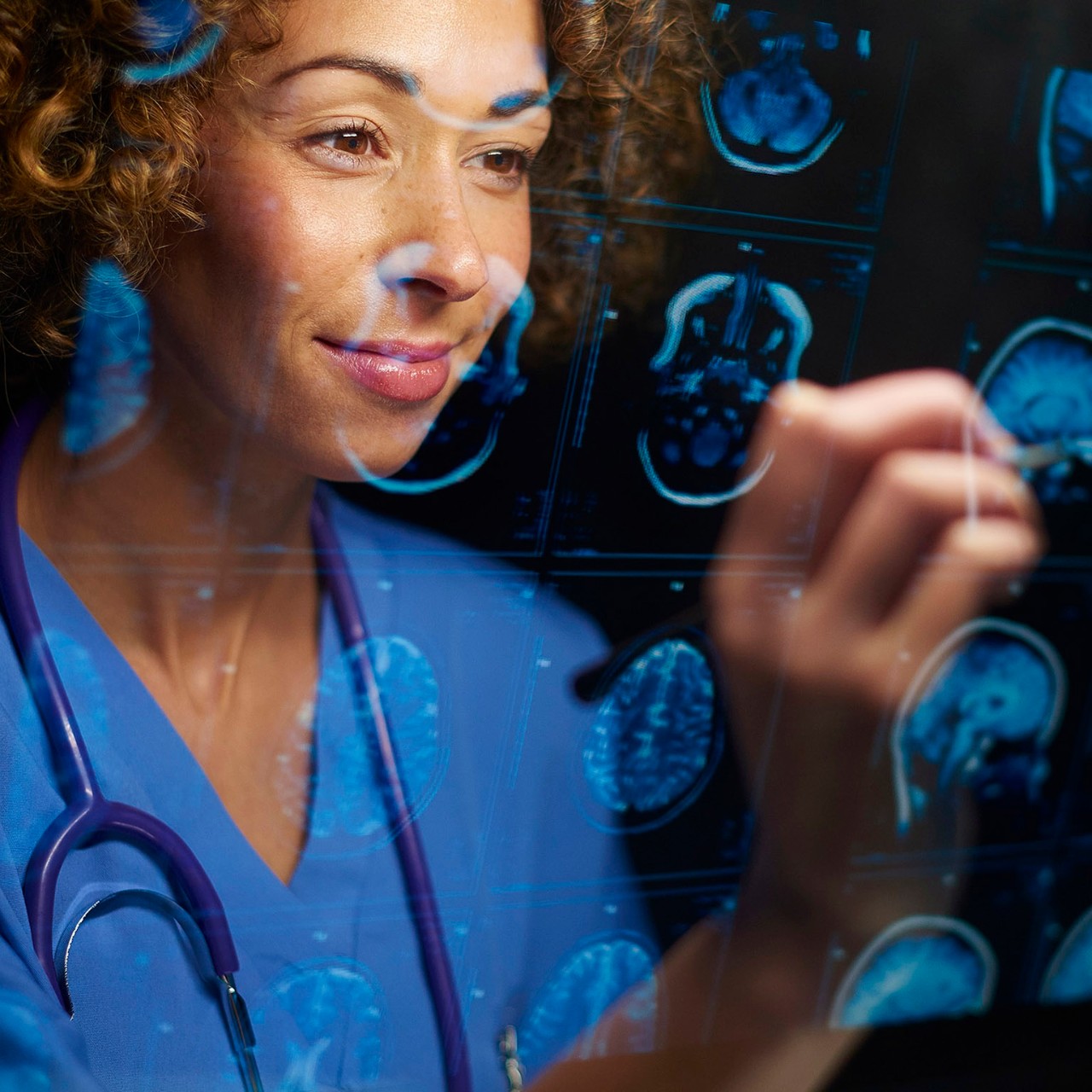 a female doctor or surgeon is analyzing the digitally generated scans of a human brain