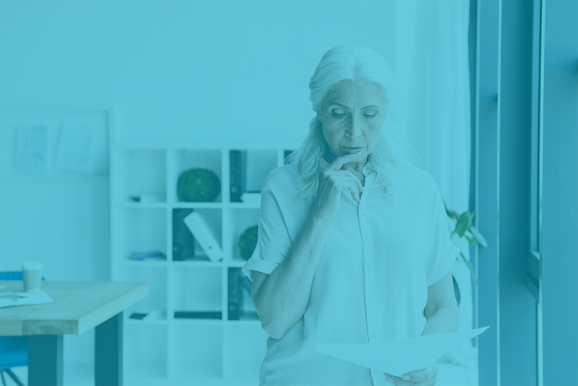 Pensive mature business woman analyzing documents