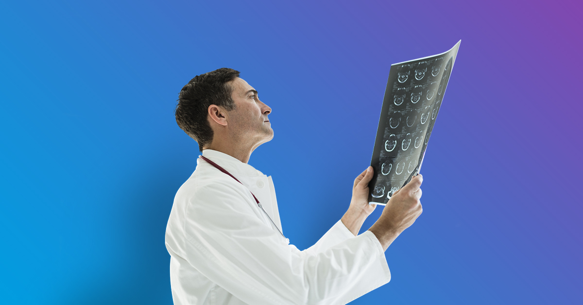 Male doctor in white lab coat looking at x-ray - blue to purple gradient