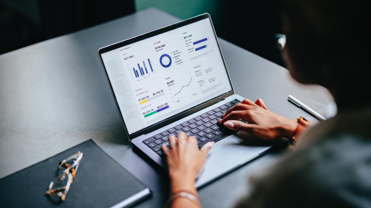 woman reviewing financial figures on laptop