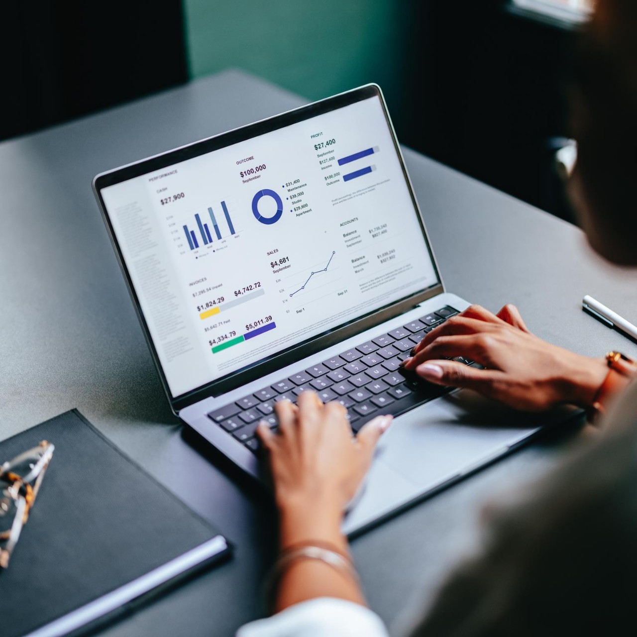 woman reviewing financial figures on laptop