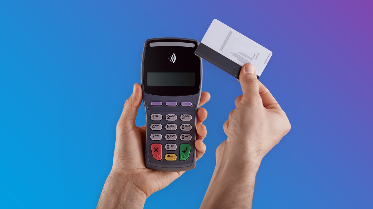 Hands holding card swipe device with credit card - blue to purple gradient