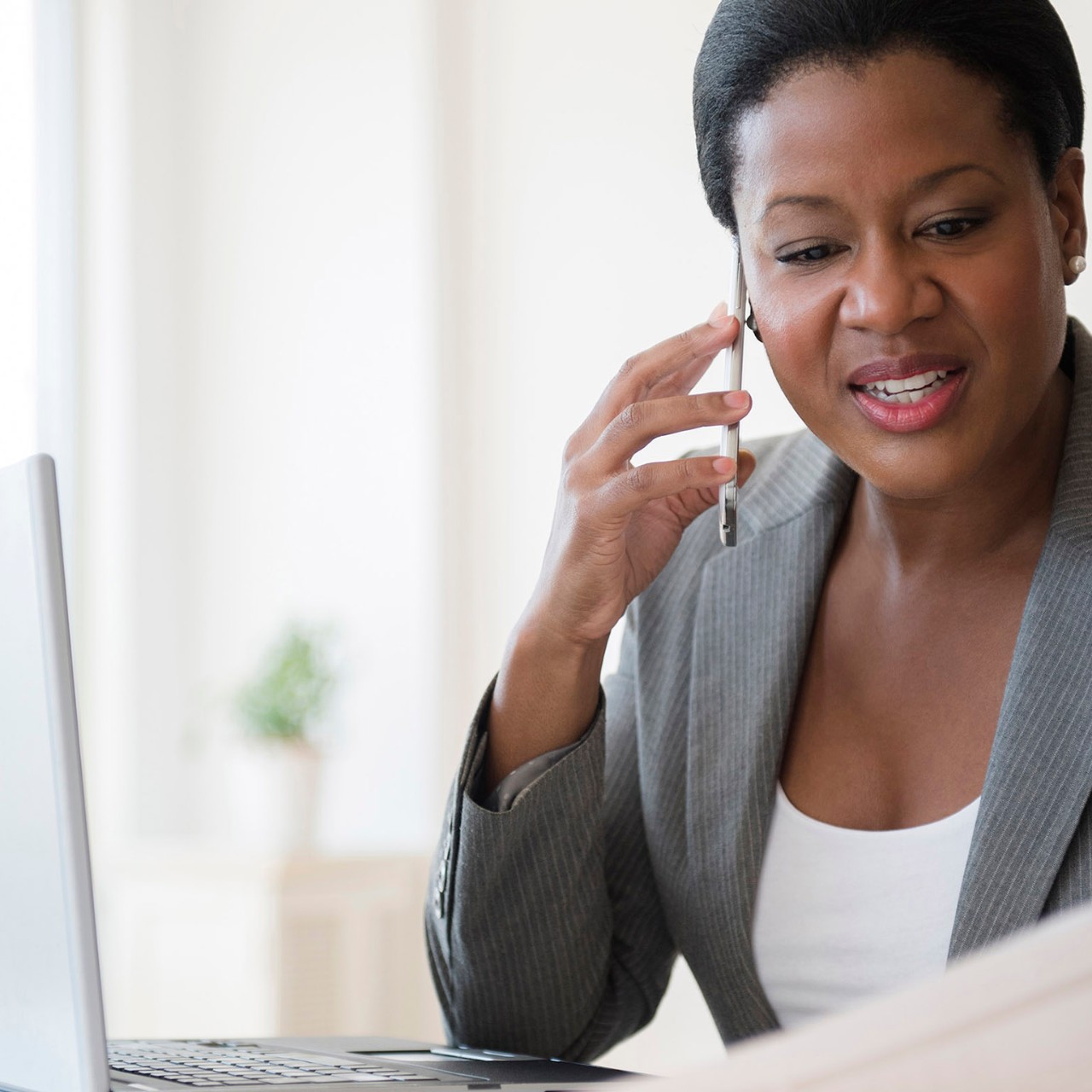 Black businesswoman talking on cell phone