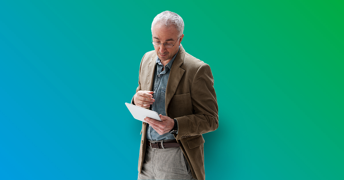 Man standing looking at tablet - blue to green gradient