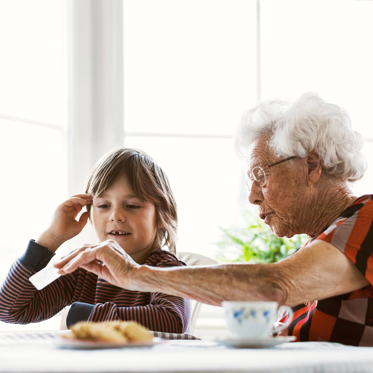 grandmother playing cards with grandson